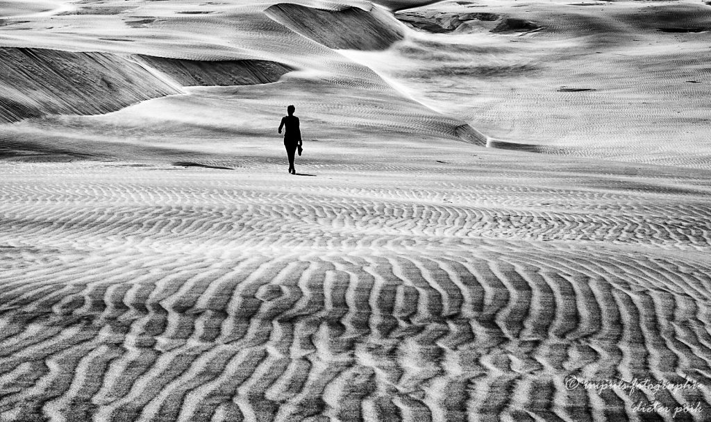 Woman walking through sand
